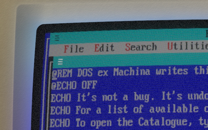 The top-left corner of the tube showing a blue text screen, with blue light on the bezel around it